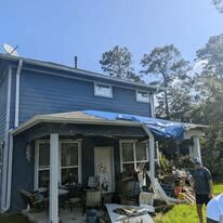 Commercial roof repair crew working on a low-slope roof